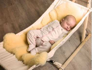 Baby sleeping on medical sheepskin