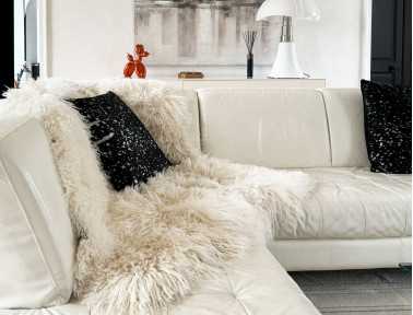 Mongolian lambskin blanket on a white sofa